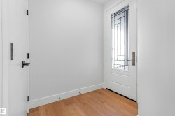 Doorway to outside with wood finished floors and baseboards - 