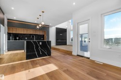 Kitchen with pendant lighting, light wood-type flooring, an island with sink, modern cabinets, and recessed lighting - 