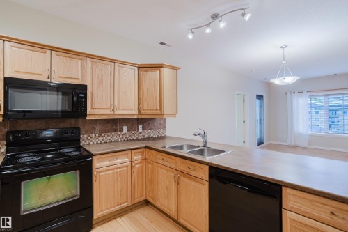 409 160 Magrath Road, Edmonton, AB - Indoor Photo Showing Kitchen With Double Sink