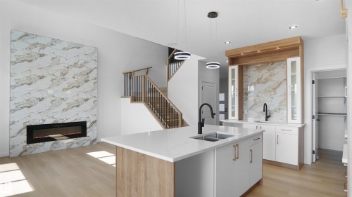 2 Axelwood Crescent, Spruce Grove, AB - Indoor Photo Showing Kitchen With Fireplace With Double Sink