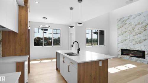 2 Axelwood Crescent, Spruce Grove, AB - Indoor Photo Showing Kitchen With Fireplace With Double Sink