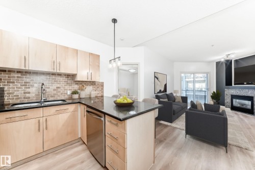 517 10235 112 Street, Edmonton, AB - Indoor Photo Showing Kitchen With Fireplace With Double Sink With Upgraded Kitchen