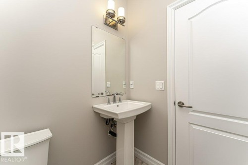 Bathroom with baseboards and toilet - 3198 Winspear Crescent Sw, Edmonton, AB - Indoor Photo Showing Bathroom