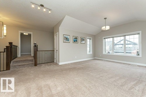 Spare room with light carpet, lofted ceiling, and a textured ceiling - 3198 Winspear Crescent Sw, Edmonton, AB - Indoor Photo Showing Other Room