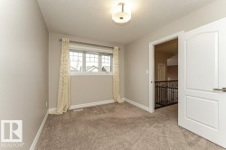 Empty room with light carpet and a textured ceiling - 