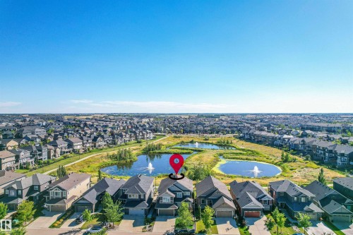 View of property location featuring a large body of water and nearby suburban area - 3198 Winspear Crescent Sw, Edmonton, AB - Outdoor With View