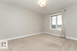 Unfurnished room with light carpet and a textured ceiling - 