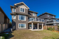 Rear view of property featuring a patio area and a fenced backyard - 