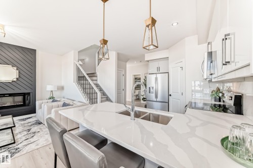 61 Patriot Way, Spruce Grove, AB - Indoor Photo Showing Kitchen With Fireplace With Double Sink