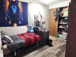 Bedroom featuring wood finished floors, a textured ceiling, and a closet - 