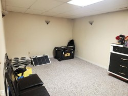 Misc room featuring carpet flooring and a drop ceiling - 