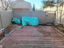 Deck with a gate and a fenced backyard - 
