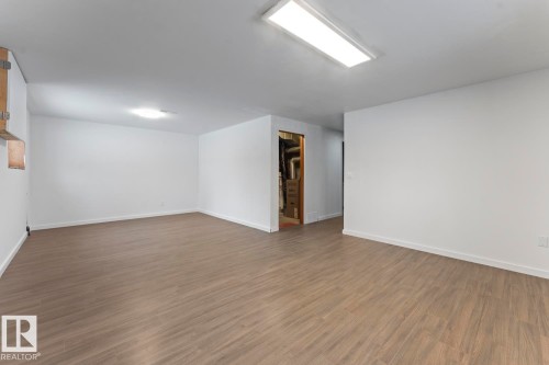 Empty room with wood finished floors and baseboards - 4719 47 Avenue, Cold Lake, AB - Indoor Photo Showing Other Room
