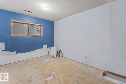 Empty room with a textured ceiling - 4719 47 Avenue, Cold Lake, AB - Indoor Photo Showing Other Room