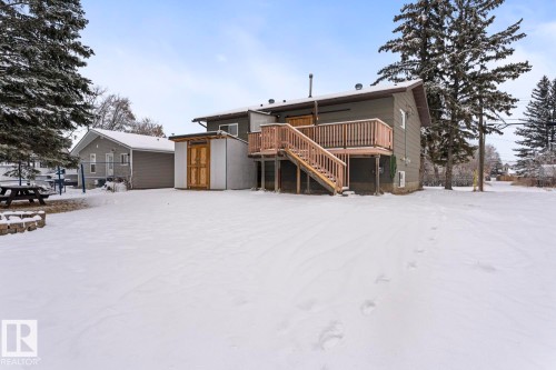Back of property with stairs, a wooden deck, and a storage unit - 4719 47 Avenue, Cold Lake, AB - Outdoor