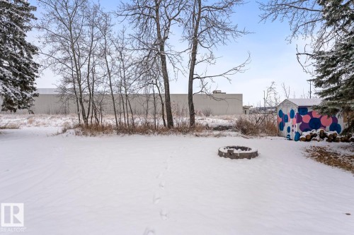 Yard layered in snow featuring a storage shed and a fire pit - 4719 47 Avenue, Cold Lake, AB - Outdoor With View
