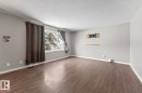 Unfurnished room featuring a textured ceiling and dark wood-style flooring - 4719 47 Avenue, Cold Lake, AB  - Indoor Photo Showing Other Room 