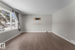 Unfurnished room with wood finished floors and a textured ceiling - 