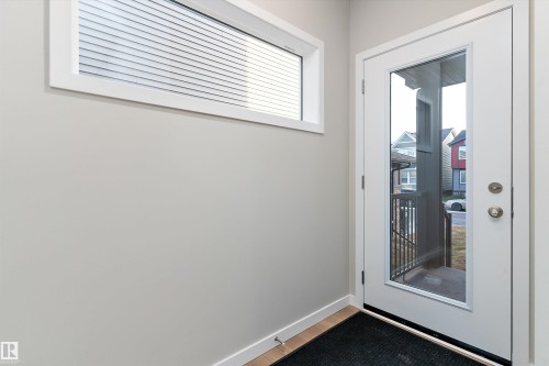 Entryway featuring baseboards and wood finished floors - 6320 King Wynd, Edmonton, AB - Indoor Photo Showing Other Room