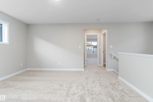 Unfurnished room with light colored carpet and baseboards - 6320 King Wynd, Edmonton, AB - Indoor Photo Showing Other Room