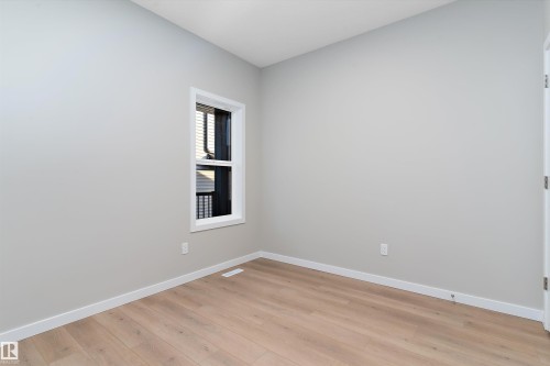 Spare room with baseboards and light wood finished floors - 6320 King Wynd, Edmonton, AB - Indoor Photo Showing Other Room