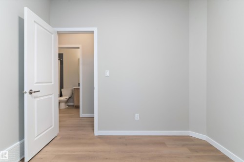 Unfurnished room with light wood finished floors and baseboards - 6320 King Wynd, Edmonton, AB - Indoor Photo Showing Other Room