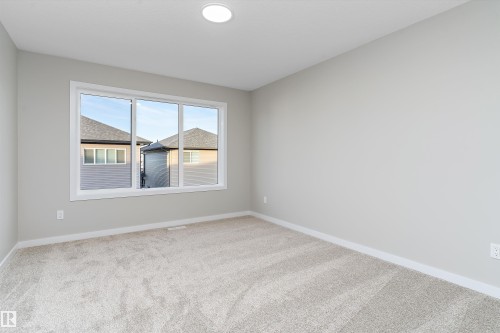 Unfurnished room with baseboards and light colored carpet - 6320 King Wynd, Edmonton, AB - Indoor Photo Showing Other Room