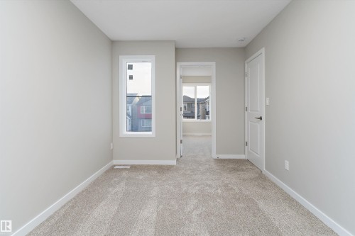 Unfurnished room with light carpet and baseboards - 6320 King Wynd, Edmonton, AB - Indoor Photo Showing Other Room