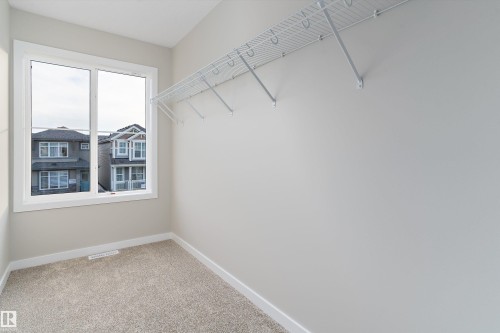 Walk in closet with light colored carpet - 6320 King Wynd, Edmonton, AB - Indoor
