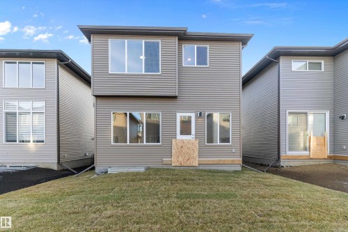 Rear view of house featuring a yard - 6320 King Wynd, Edmonton, AB - Outdoor With Exterior