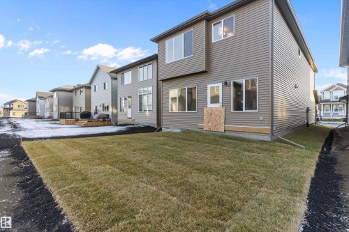 Rear view of property with a wooden deck, a residential view, and a yard - 6320 King Wynd, Edmonton, AB - Outdoor