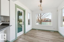 Unfurnished dining area featuring light wood-style flooring and a textured ceiling - 
