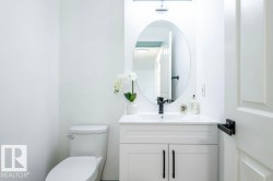 Half bath featuring vanity and toilet - 