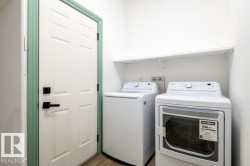 Laundry room featuring washing machine and clothes dryer and light wood-style flooring - 