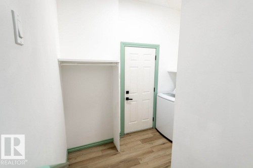 Washroom featuring light wood-style floors and washer / dryer - 1112 118A Street Nw, Edmonton, AB - Indoor Photo Showing Other Room
