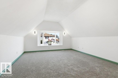 Additional living space with vaulted ceiling and carpet floors - 1112 118A Street Nw, Edmonton, AB - Indoor Photo Showing Other Room