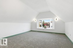Additional living space featuring vaulted ceiling and carpet flooring - 