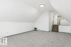 Bonus room with carpet flooring, lofted ceiling, and stairs - 