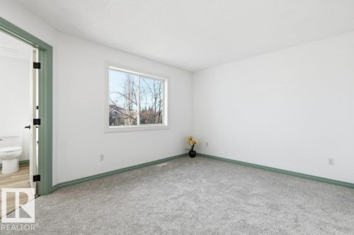 Carpeted spare room featuring baseboards - 1112 118A Street Nw, Edmonton, AB - Indoor Photo Showing Other Room