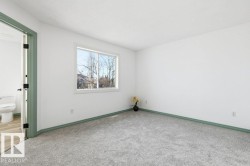 Carpeted spare room featuring baseboards - 