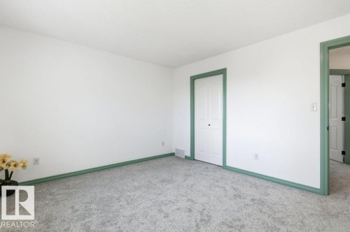 Unfurnished bedroom featuring carpet and a closet - 1112 118A Street Nw, Edmonton, AB - Indoor Photo Showing Other Room