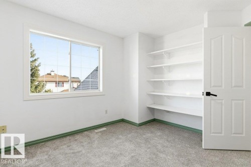 Unfurnished room with a textured ceiling and light carpet - 1112 118A Street Nw, Edmonton, AB - Indoor Photo Showing Other Room