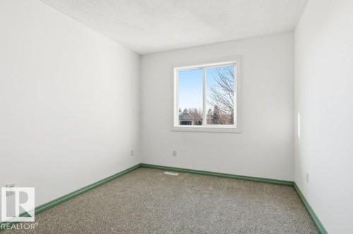 Carpeted spare room with a textured ceiling and baseboards - 1112 118A Street Nw, Edmonton, AB - Indoor Photo Showing Other Room