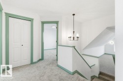 Stairway featuring carpet and a chandelier - 