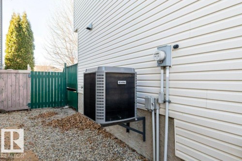 Exterior view of a cooling unit and electric meter - 1112 118A Street Nw, Edmonton, AB - Outdoor With Exterior