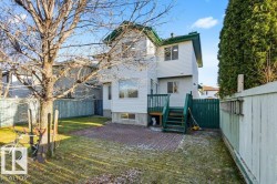 Rear view of property with a fenced backyard, a chimney, and a deck - 