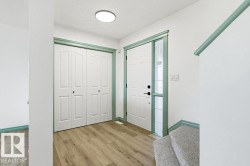 Foyer entrance with light wood finished floors and a textured ceiling - 