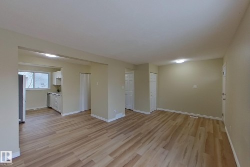 Unfurnished living room with baseboards and light wood-style floors - 112 Dickinsfield Court Nw, Edmonton, AB - Indoor Photo Showing Other Room