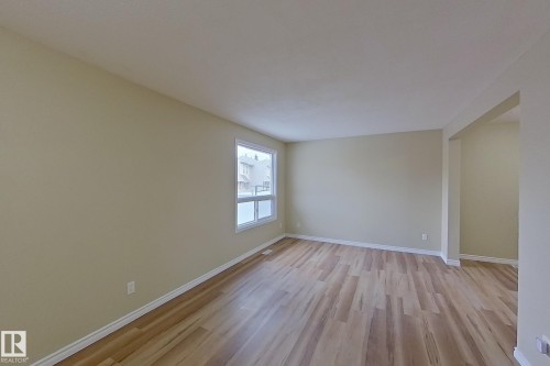 Unfurnished room with baseboards and light wood-type flooring - 112 Dickinsfield Court Nw, Edmonton, AB - Indoor Photo Showing Other Room