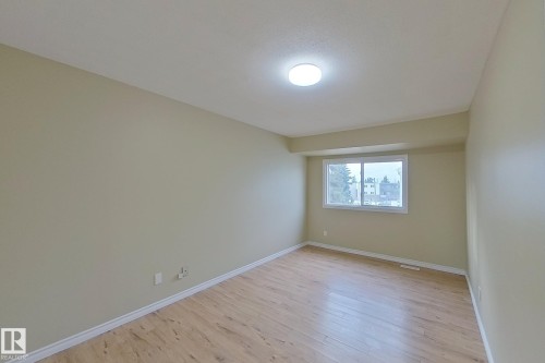 Empty room with light wood-style flooring and baseboards - 112 Dickinsfield Court Nw, Edmonton, AB - Indoor Photo Showing Other Room